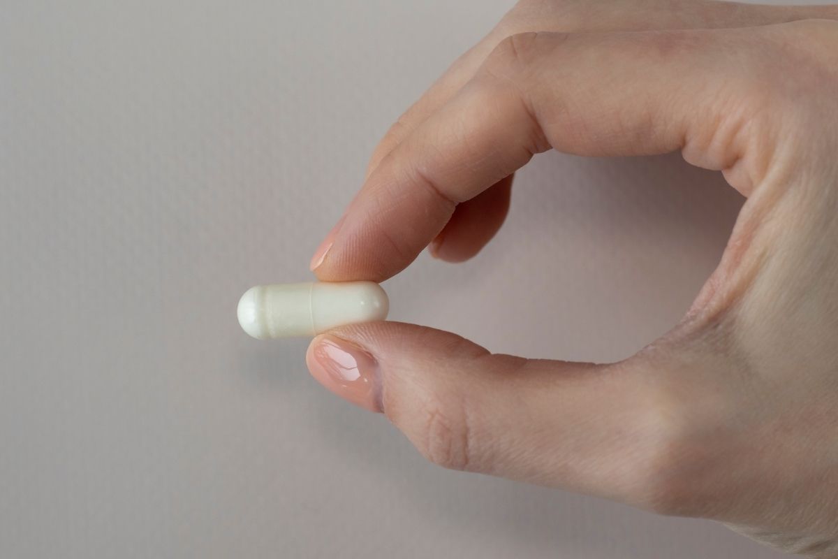 Woman holding nattokinase supplement