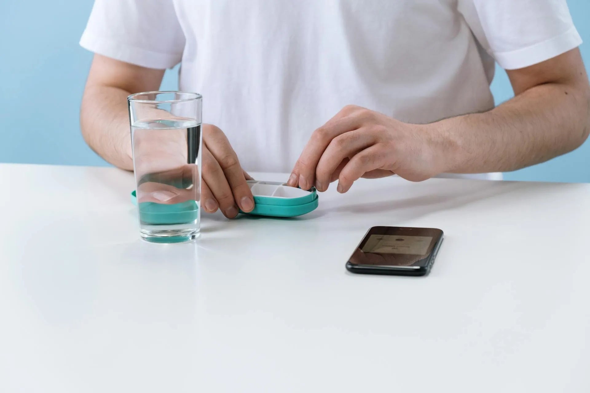 a man taking his daily supplements